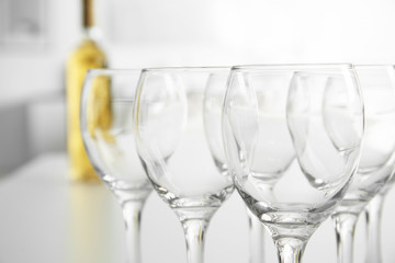 Wineglasses on blurred interior background