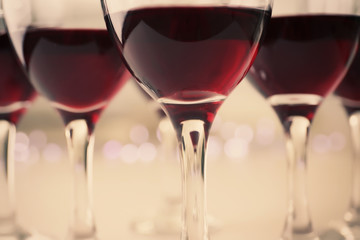Glasses of red wine on white table closeup