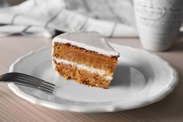 Tasty slice of carrot cake on white plate