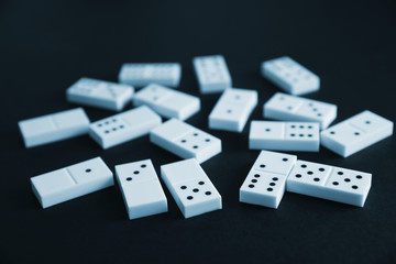 Heap of dominoes on black background