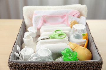 Fototapeta na wymiar Wicker basket full of baby accessories for hygiene