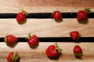 A few berries ripe strawberries on wooden plates, top view
