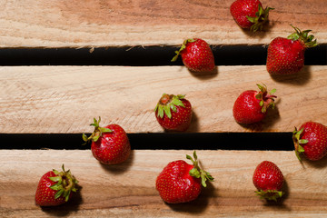 A few berries ripe strawberries on wooden plates, empty space, top view