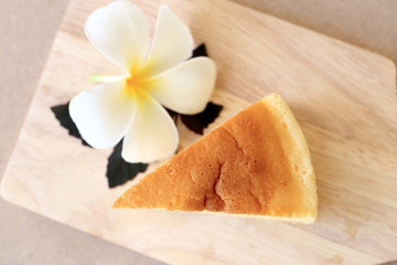Pieces of Japanese style Cheesecake, top view on wooden plate.
