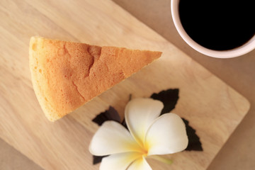 Pieces of Japanese style Cheesecake and cup of black coffee, top