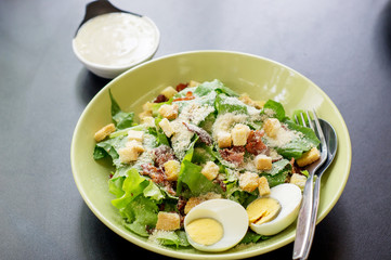 Caesar salad in a white bowl.