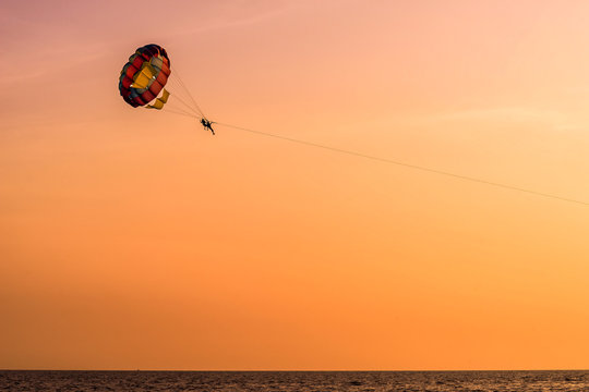 Parasailing during sunset in Goa with large copy space