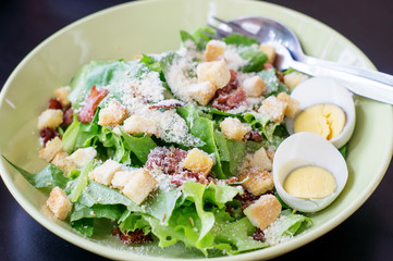 Caesar salad in a white bowl.