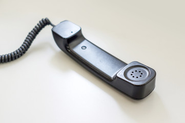 black telephone picking on a desk, soft focus.