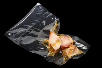vacuum packaged pieces of sturgeon on the black background - 116391972