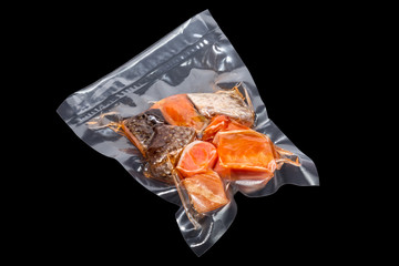 vacuum packaged pieces of salmon on the black background - 116391979
