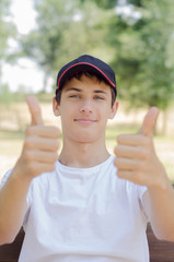 Close up portrait of a cute teenager in a baseball cap.