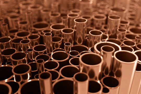 Industry business production and heavy metallurgical industrial products, many shiny steel pipes, industrial background, manufacturing business production concept, copper pipes with selective focus