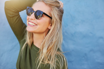 Cheerful young woman in sunglasses