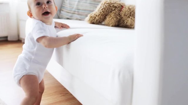 happy little baby crawling in living room at home 3