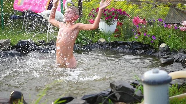 child splashing in the pool