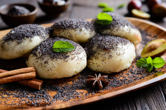Sweet steamed dumplings with a plum jam sprinkled with ground poppy seeds