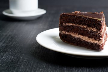 piece of chocolate cake on a dark background