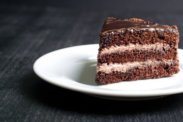 piece of chocolate cake on a dark background