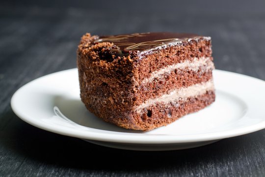 piece of chocolate cake on a dark background
