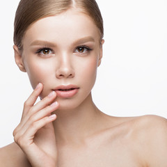 Beautiful young girl with a light natural make-up and French manicure. Beauty face.