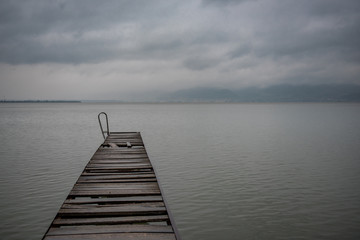 Obraz premium Old wooden dock in summer stormy weather
