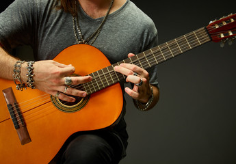 Obraz premium The guy playing an acoustic guitar.