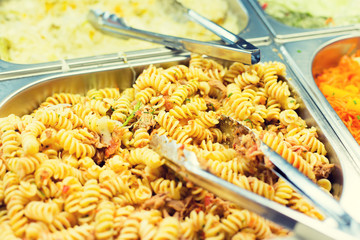 close up of pasta and dishes on catering tray