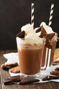 Hot Chocolate with Whipped Cream and Homemade Biscuit Cookies on old wooden background, selective focus