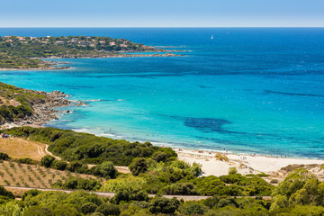Fototapeta na wymiar Holidaymakers and turquoise Mediterranean at Bodri beach in Cors