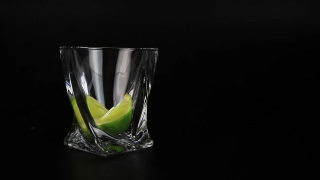 Caipirinha with cachaca, sugar and lime on black background
