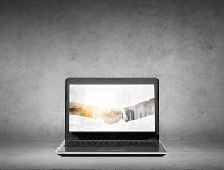 laptop computer with handshake on screen
