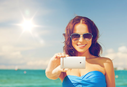 woman in bikini with phone
