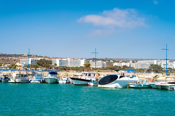 Fototapeta na wymiar Fishing and cruise boats in a harbor, Agia Napa, Cyprus