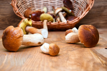 Fresh mushrooms in basket on wooden table