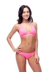 Fototapeta premium happy young woman in pink bikini swimsuit
