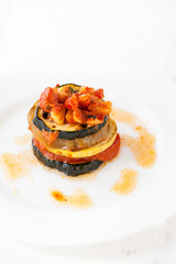 A white plate with ratatouille