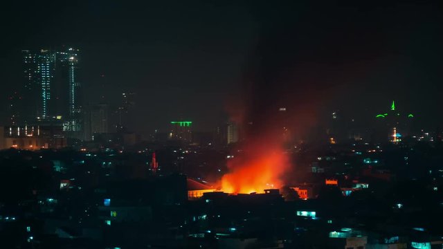 Big fire in city Jakarta, burning building. 4K Timelapse - Jakarta, Java, Indonesia, June 2016.