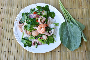 stir fried Chinese kale with mixed seafood on rice