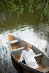 little girl in the boat at the river