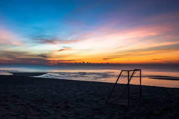 beautiful sunset sunrise background on the beach with silhouette small in the foreground