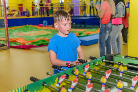 Little Boy Playing A Table Board Game Of Soccer