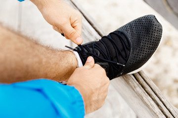 Runner laces his shoes and prepares to jogging