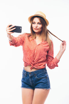 Happy cute woman making selfie over white background.