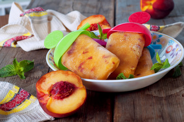 Peach ice lollies on a kitchen napkin