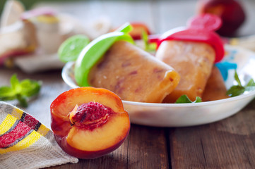 Peach ice lollies on a kitchen napkin