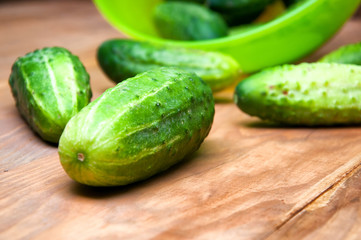 Mini cucumbers in bowl on table
