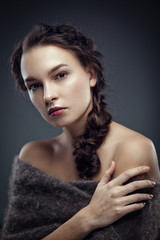 Fashion portrait of brunette in fur cape