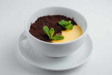 chocolate-lemon dessert in a white cup on a white background