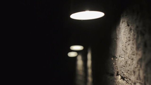 Lights on the wall. Three lights shine on the black wall. Established atmosphere terrible dark basement.